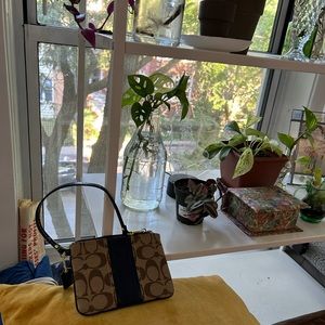 Women’s Coach wristlet with iconic C branding blue and brown